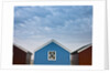 Beach huts in a row against sky by Assaf Frank